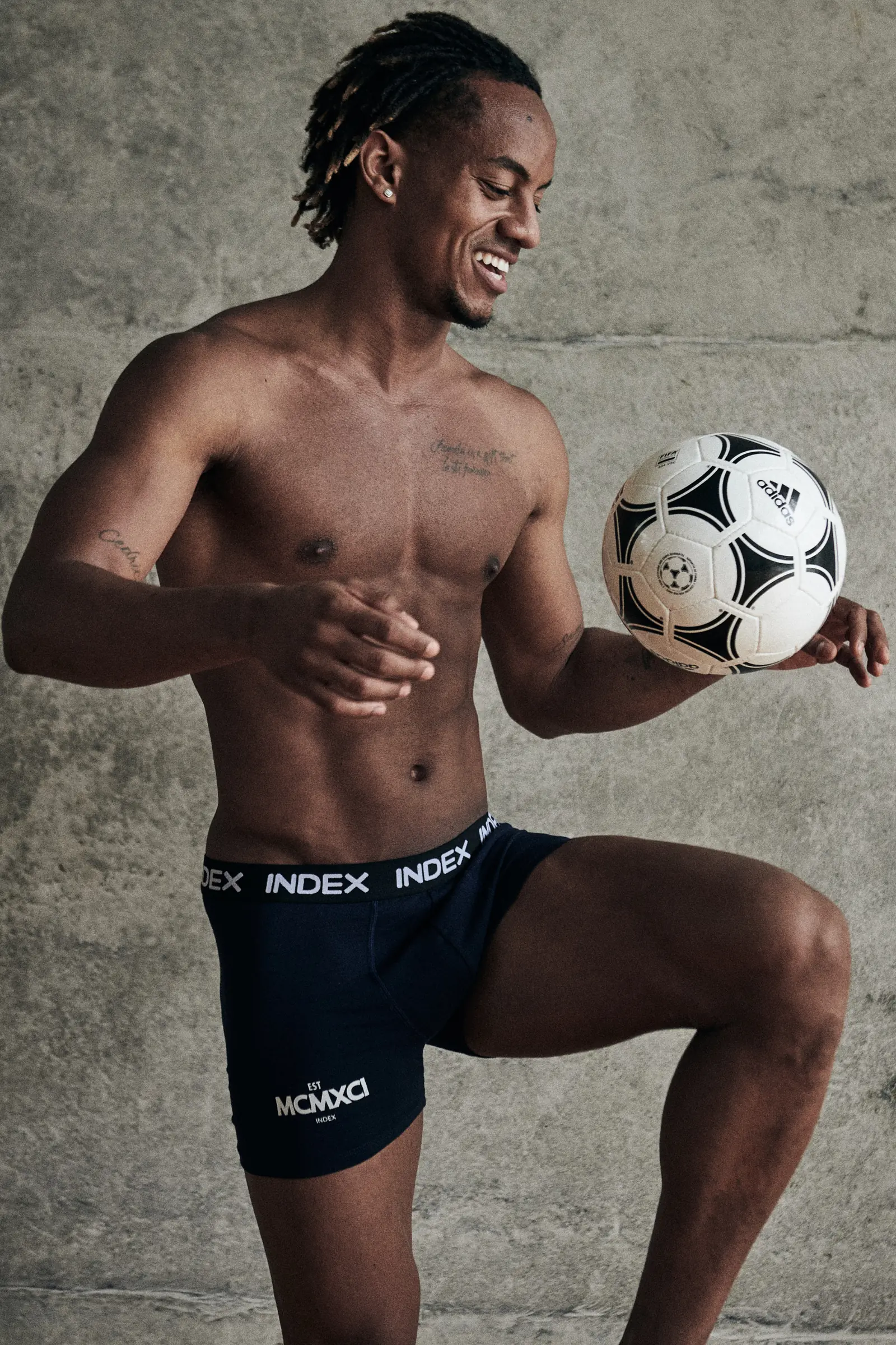 André Carrillo with a football — menswear campaign photographed by Javier Falcón in Lima