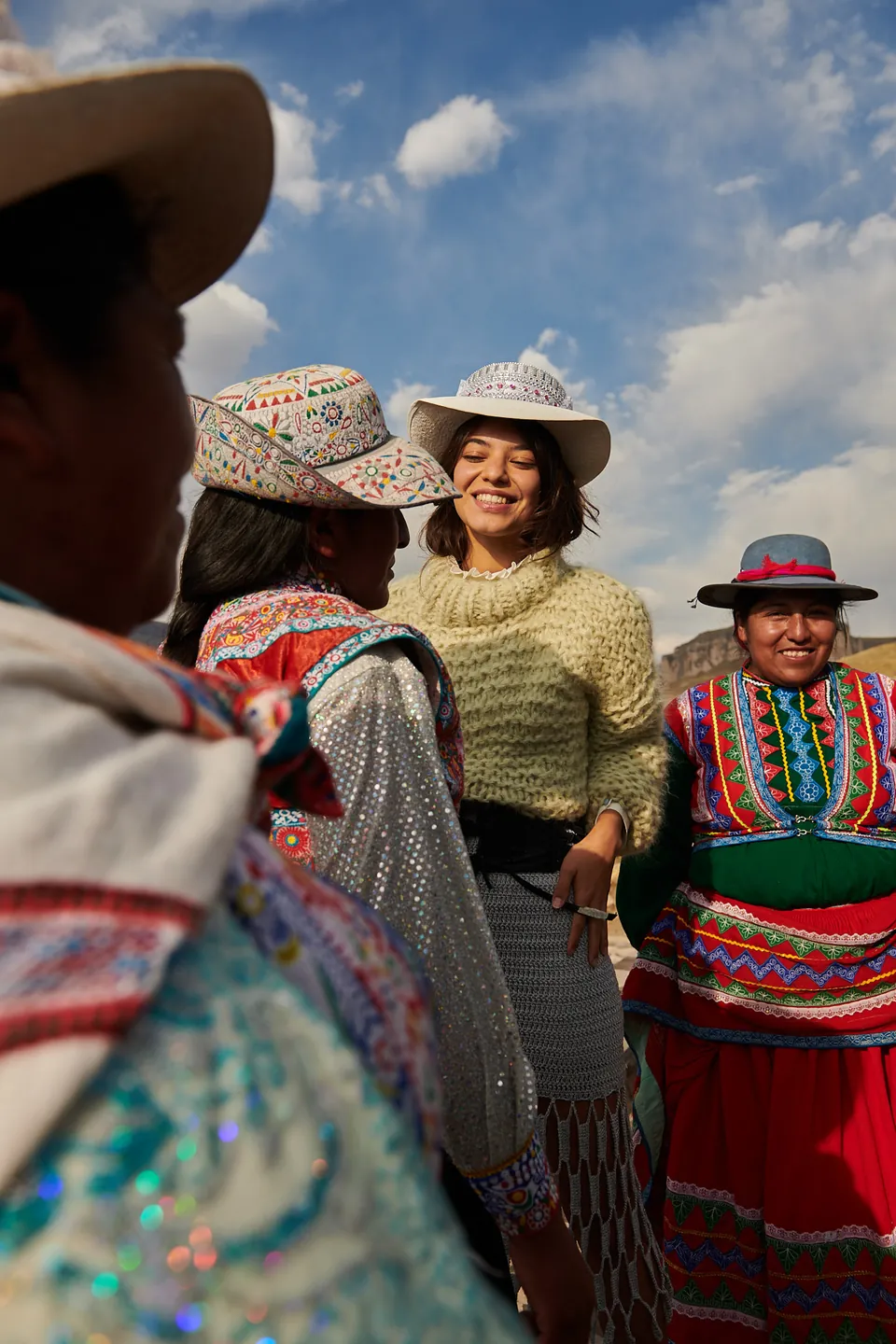 Model with women of the Colca Valley in traditional dress, photographed by Javier Falcón