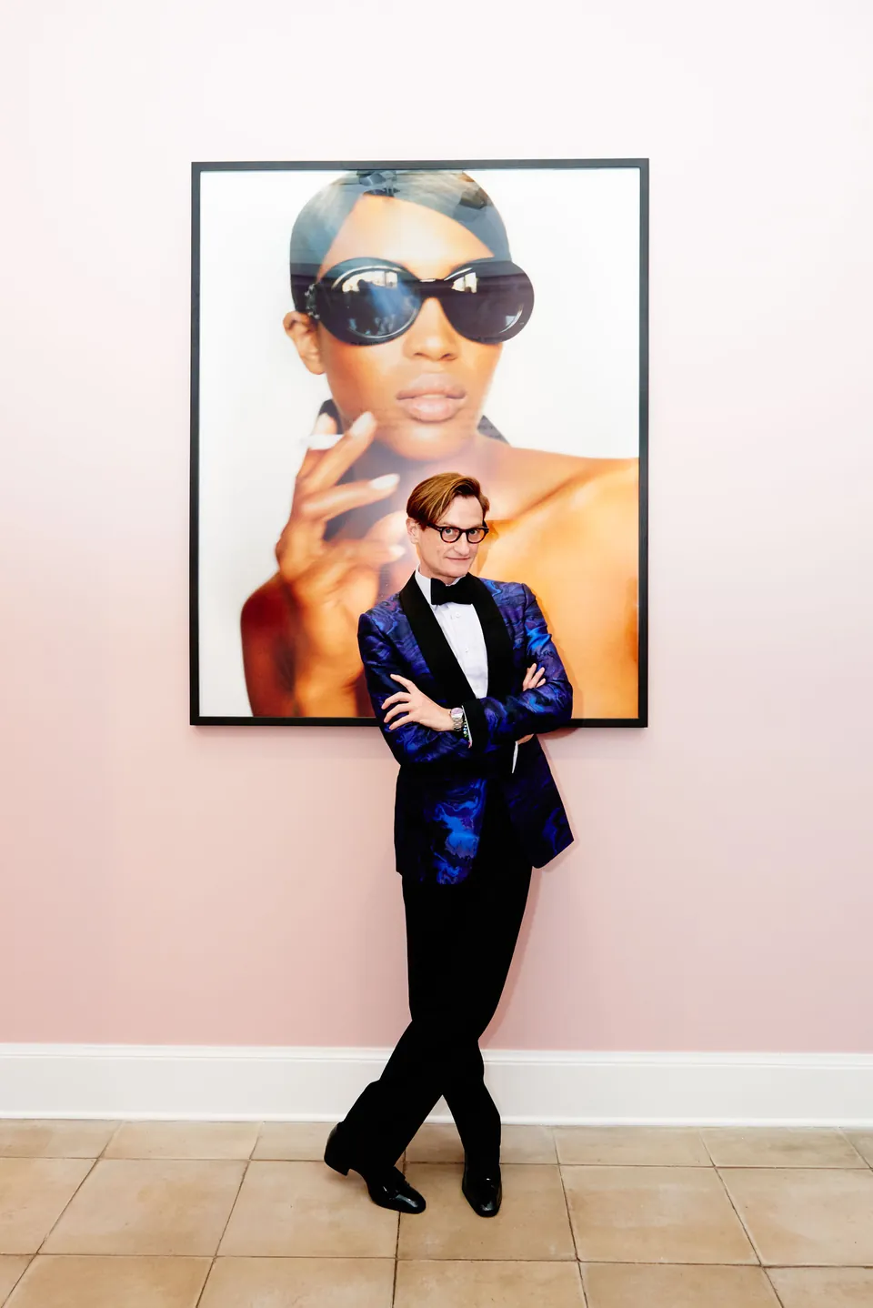 Portrait of Hamish Bowles in a blue tuxedo at an art gallery, by Javier Falcón